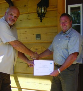Rick Kinsmasn of Confederation Log & Timber Frame is presented with Energy Star certification